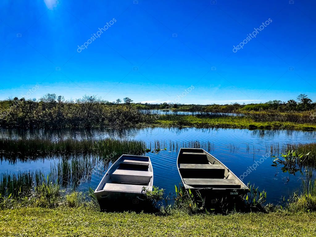 Boat gliding through coastal marshes along the Louisiana coast
